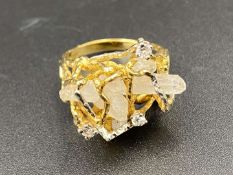 A large quartz and diamond set, 18ct gold dress ring.