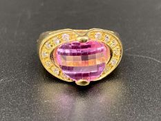 A pink and white stone set dress ring in 18 ct yellow gold mount.