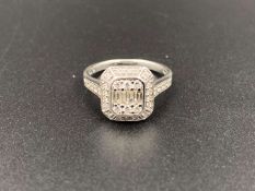 BEAVERBROOKS, a round brilliant and baguette set, diamond and 18 ct white gold ring.
