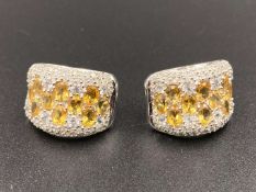 A pair of .63ct diamond and citrine set, 14 ct gold earings.