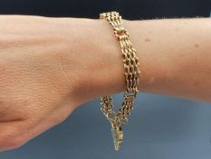 A 9ct gold graduated gate link bracelet with heart shaped padlock clasp