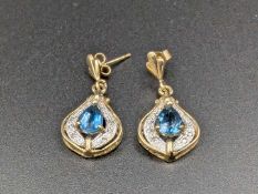 A pair of blue Topaz & Diamond 9ct gold earrings