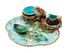 A George Jones majolica strawberry dish with cream jug, sugar bowl and ladle,