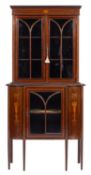 An Edwardian mahogany and glazed serpentine-front display cabinet,