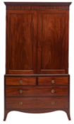 A Regency mahogany linen press, early 19th century; with moulded cornice above twin panel doors,