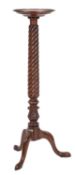 A carved mahogany circular torchere stand, in the Regency taste,
