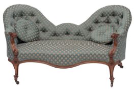 A Victorian carved walnut and upholstered conversation sofa,