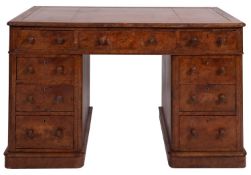 A walnut and leather inset pedestal desk in Regency style,