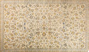 A Kashan carpet, the pistachio field with an all over Shah Abbas design of scrolling palmettes,