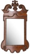 A carved walnut and parcel gilt wall mirror in George I style,