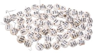 A collection of ceramic wine bin labels, of circular form and pierced for attachment,