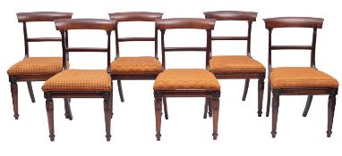 A set of six Regency rosewood dining chairs, circa 1815; each with curved and out-scrolled top rail,