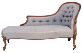 A Victorian walnut and button upholstered chaise longue,