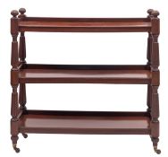 A William IV mahogany three-tier buffet, circa 1835; with lobed finials at the upper corners,