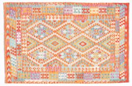 An Anatolian Turkish Kelim, the serrated lozenge field in vibrant colours of orange, green,