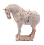 A Chinese painted pottery horse in Tang style modeled with head lowered and open mouth,