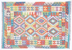 An Anatolian Turkish Kelim, the serrated lozenge field in vibrant colours of orange, green,