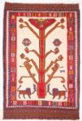 A Qashgai Kelim, the ivory field with two lions at the foot of a stylised tree,