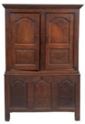 An 18th-century oak side cupboard; in two sections,