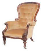 A Victorian walnut and button upholstered armchair,