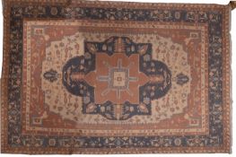 A Turkish carpet, the beige field with a central indigo, camel and beige geometric pole medallion,