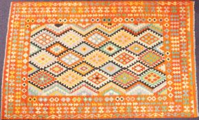 An Anatolian Turkish Kelim, the field with serrated lozenge medallions in bright multiple colours,