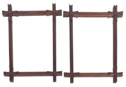 A pair of oak framed wall mirrors, possibly North American, circa 1900; of rectangular form,
