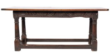A mid 17th-century oak rectangular serving table; frieze with incised carved scrolling foliage,