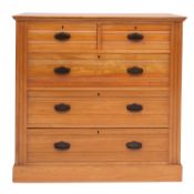 An Edwardian ash chest of drawers by Harris Lebus of London, probably for Maple & Co.