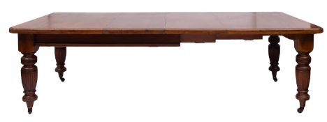 A Victorian walnut extending dining table, last quarter 19th century; the top with moulded edges,