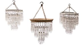 A pair of cut glass and silver painted metal electroliers,