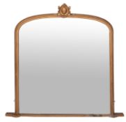 A Victorian giltwood and composition framed overmantel mirror, circa 1875; of shallow arched form,