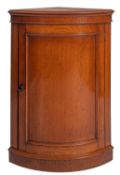 A Victorian oak corner cabinet, late 19th century; the top with moulded edge,