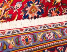 A Shadsar signed Kashan rug, the shaded wine cartouche field with a cartouche pendant medallion,