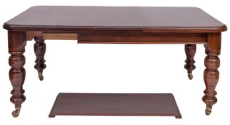 A Victorian walnut extending dining table, late 19th century; the the top with rounded corners,
