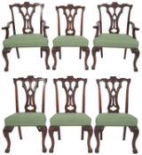 A set of six carved mahogany and upholstered dining chairs in Chippendale style,