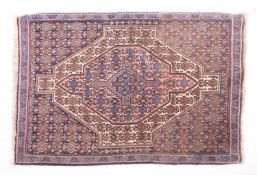 A Hamadan rug, the field with a central rose pointed panel,