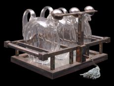 *Jacques Adnet (1900-1984), an Art Deco Tantalus; 1930s, with a chromium plated metal frame,
