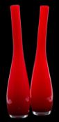A pair of Murano cased glass vases, the red over white body of slender asymmetric form, 48cm high.