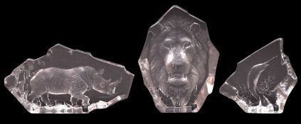 Three Mats Jonasson clear glass paperweights, each intaglio decorated with a lion,