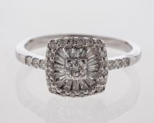 A diamond cluster ring with unusual setting of central diamond and baguette cut diamonds in