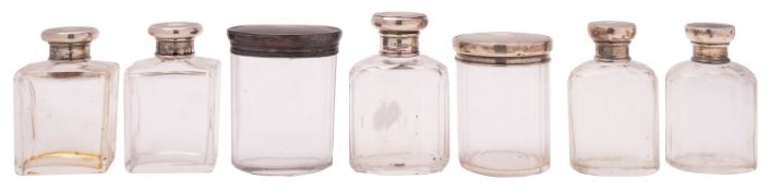 Seven various silver lidded glass bottles and jars,