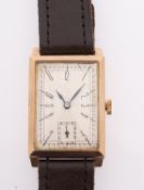 A gentlemen's 9ct gold wristwatch the rectangular dial with stylised black Roman numerals and
