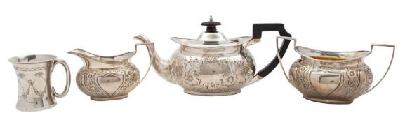 An Edwardian silver three piece tea service by James Deakin & Sons, Sheffield 1902, rounded oval,