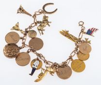 A gold bracelet with charms, including a pair of skis, Eiffel tower,