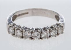 A platinum diamond half eternity ring set with round brilliant cut stones in platinum,
