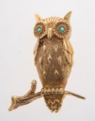 A gold Owl brooch the eyes set with small emeralds, length 3.
