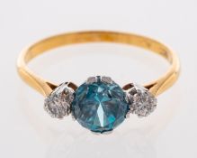 A Three stone ring set with natural blue zircon and two brilliant cut diamonds,