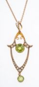 An Edwardian peridot and seed pearl pendant, on fine gold chain.