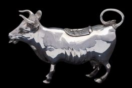 A late Victorian silver cow creamer by Maurice Freeman, London 1900, with a bee to the hinged cover,